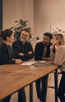 A leadership team in a discussion around a table