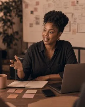 A project manager in front of a planning whiteboard
